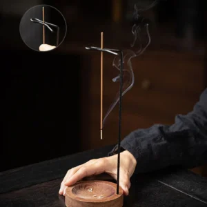 Minimalist wooden inverted incense holder releasing smoke in a zen-inspired interior
